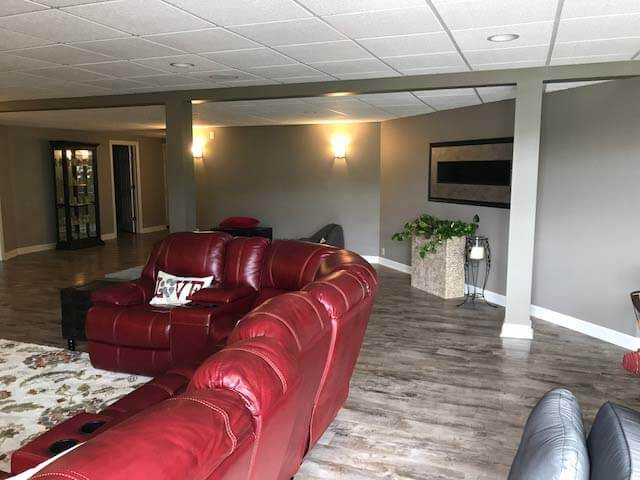 Basement Remodel with stone feature wall and flooring